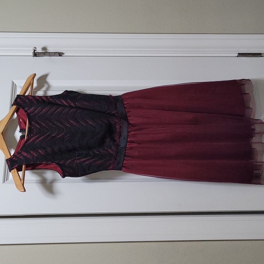Burgundy dress with black design on the top art of the dress. Size Small